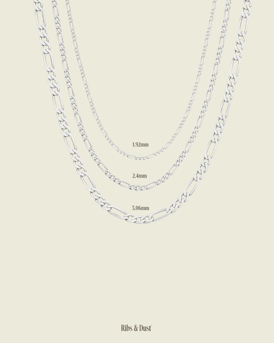 Three White Gold chain necklaces of different thicknesses on a beige background, with 'Ribs & Dust' branding.  Figaro style